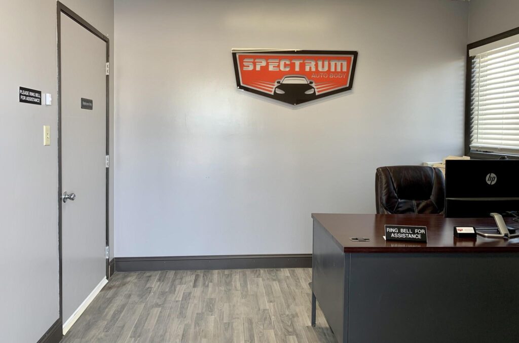 Spectrum Auto Body front office and sign at 727 E Main St, Belle Plaine